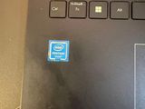 a close up of a laptop with a blue sticker on it