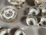 many different types of porcelain dishes and cups on the table