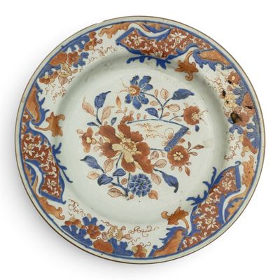 a plate with a floral design on it on a white surface