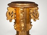 a gold pedestal with a marble top on a white background
