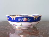 a blue and white bowl sitting on a marble table