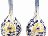 pair of blue and white vases with gold accents on stands