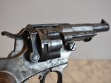 a gun that is on a table with a person holding it