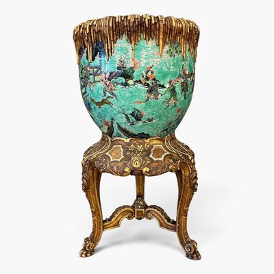 un vase vert posé sur une chaise en bois