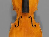 an old violin with a bow on a gray background