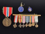 several medals and medals hang from a wooden rack on a black background