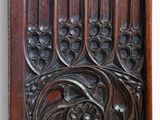 carved wood panel with a design of flowers and vines