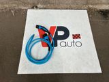 a blue hose sitting on the ground next to a sign