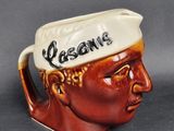 a ceramic mug with a man ' s head and name on it