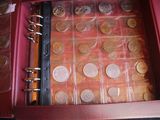 a red case with a bunch of coins inside of it