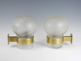 pair of glass and brass sconces with frosted glass globes