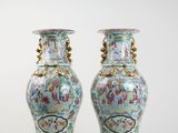 pair of vases sitting on a white surface with a white background