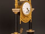a clock that is sitting on top of a wooden table