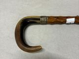 a wooden handle with a metal ring on it