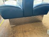 a blue couch sitting on a wooden floor in a room