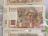 a man holding a bunch of money in his hand