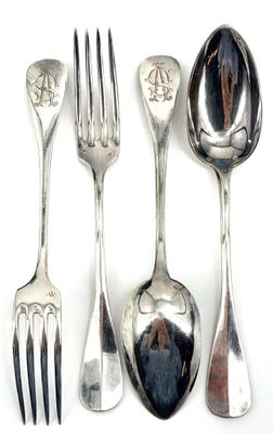 four spoons and a fork on a white surface