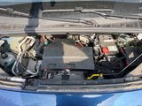 a blue car with a bunch of batteries in it