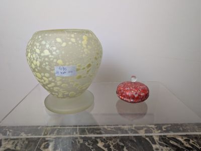 two vases sitting on a glass table with a label on it