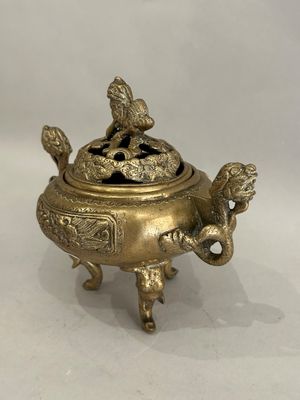 an image of a brass incense box with a bird on top
