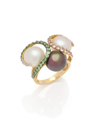 a close up of a ring with pearls and diamonds