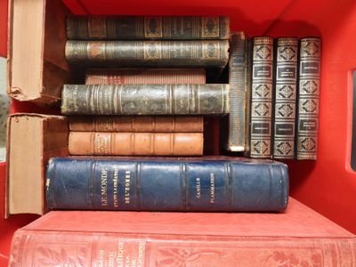 many books stacked on top of each other in a red box