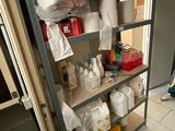 a shelf with toilet paper, toilet paper rolls, and other items on it
