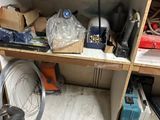 a shelf full of tools and other items in a room