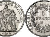 a silver coin with the image of a man and woman on it