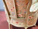 two chairs sitting next to each other on a pink floor
