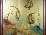 tableau représentant un groupe de poissons nageant dans l'océan au milieu des coraux