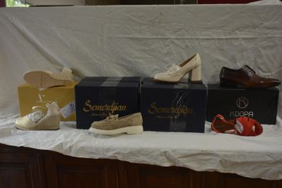 several pairs of women ' s shoes are lined up on a table