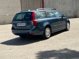a small blue car parked in a parking lot