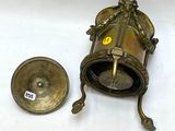 a small brass bell and a small brass bell on a white surface