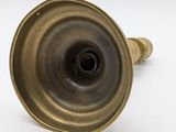 pair of antique brass candlesticks on a white background