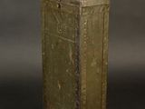 an old metal box sitting on top of a black surface