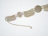 silver plated bracelet with five discs and a chain on a white surface