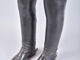 pair of black leather boots with gold buckles on the toes