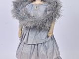 an image of a doll with a feathered dress and a hat