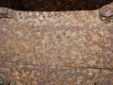 a rusted metal box with a number on it
