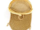 an image of a gold purse with a chain around it