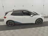 a white car is parked in a room with a checkered floor