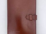 a brown leather notebook with a diamond on the front