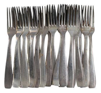 six forks are arranged in a row on a white surface