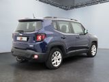 the back end of a blue jeep compass parked in a garage