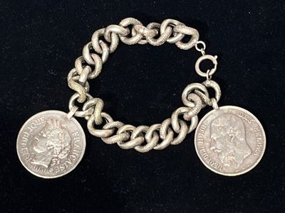 an image of a bracelet with two coins attached to it