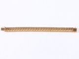 a close up of a gold bracelet on a white background
