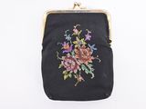 black purse with flowers on it hanging from a chain