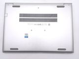 a close up of a silver laptop with a blue sticker on it