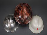 two hard hats and a hard hat on a table